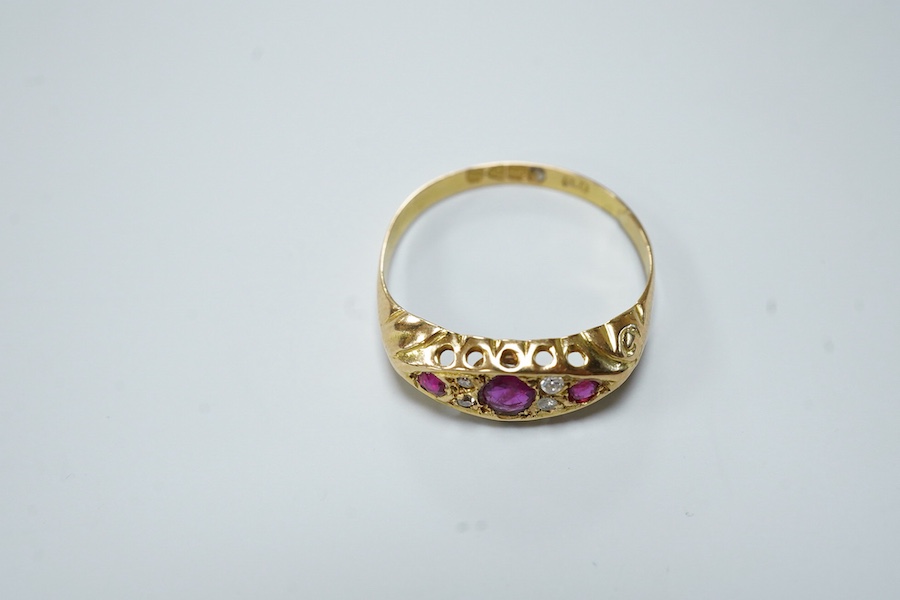 A ruby and diamond ring, circa 1916, set with three circular-cut rubies, spaced by pairs of circular-cut diamonds, mounted in 18ct gold, size R1/2, British hallmarks, gross weight approximately 2 grams, one ruby syntheti